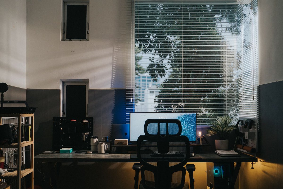 Home-office desk with a desktop monitor under a window
