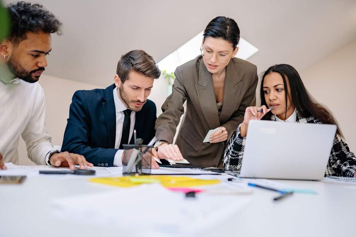 Business team working at a desk with documents and a laptop
