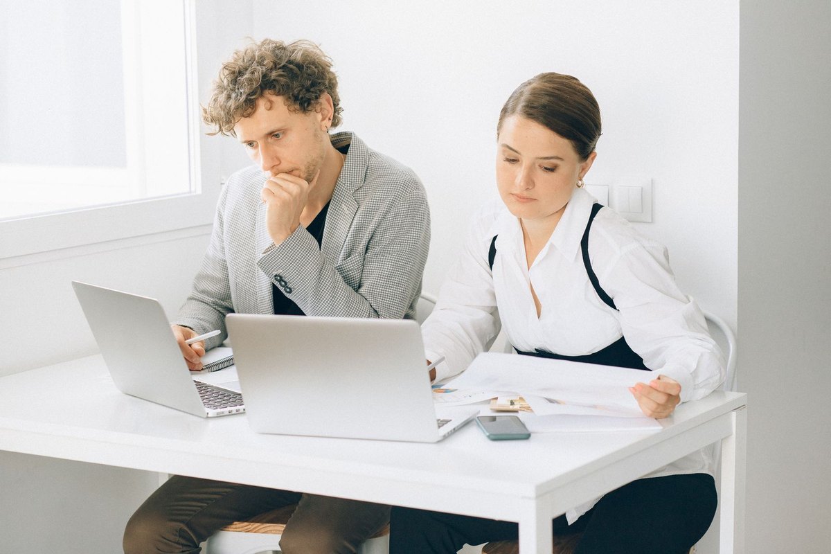 Business colleagues working together on laptops and documents
