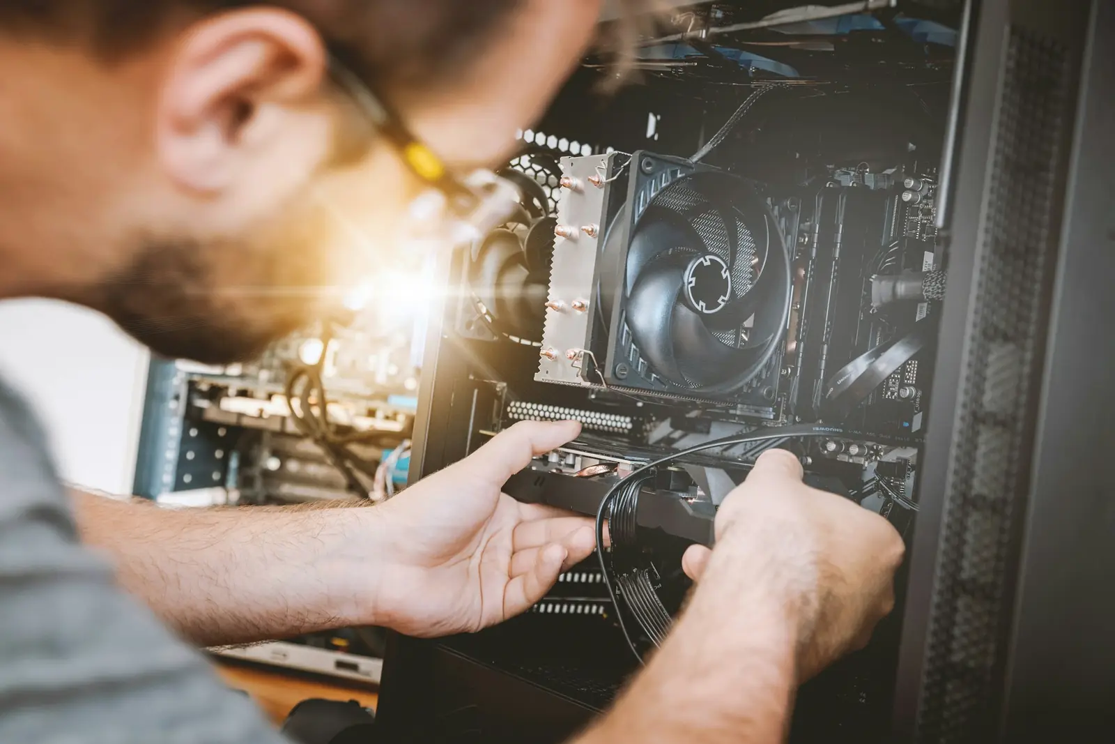 Technician installing a graphics card in a desktop computer