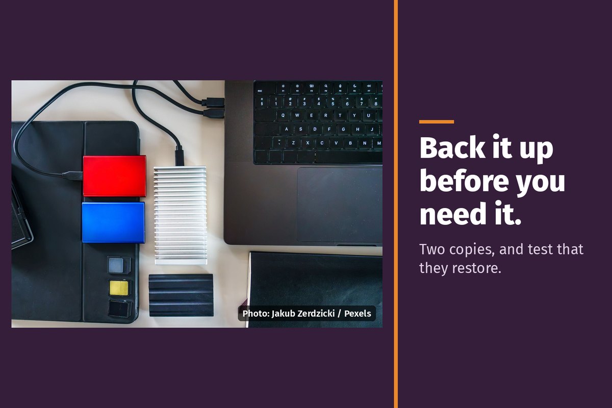 Portable drives next to a laptop, with the words "Back it up before you need it. Two copies, and test that they restore."